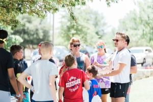 group of people standing on green grass field during daytime