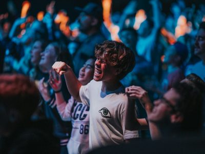 group of people holding hands while watching performance